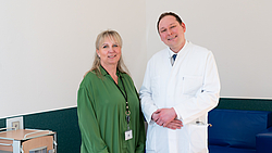 2 Personen stehen Freude strahlend nebeneinander